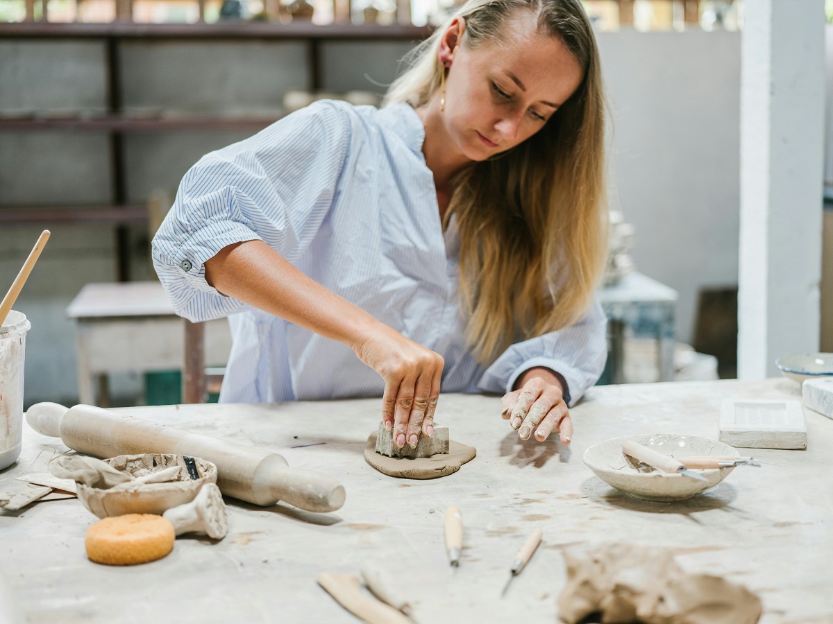 woman working with pottery clay